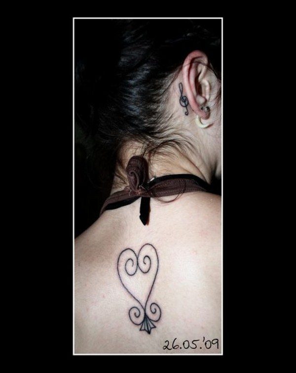 Kiki - Sankofa & treble clef tattoo